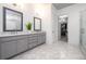Bright bathroom featuring double vanity, marble floors, and walk in closet at 1110 Briar Cove Cir, Atlanta, GA 30329