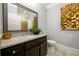Stylish bathroom featuring a dark vanity with granite countertops, large mirror, and modern decor at 1110 Briar Cove Cir, Atlanta, GA 30329