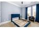 Bedroom featuring gray walls, tan carpet, and blue velvet headboard at 1110 Briar Cove Cir, Atlanta, GA 30329