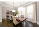 Bright dining room featuring hardwood floors, modern light fixtures, and large windows at 1110 Briar Cove Cir, Atlanta, GA 30329