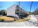 Street view of modern townhomes with black and white exteriors and sidewalk access at 1110 Briar Cove Cir, Atlanta, GA 30329