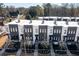 Modern townhome exteriors featuring a sleek gray and white design with black-framed windows and well-maintained landscaping at 1110 Briar Cove Cir, Atlanta, GA 30329