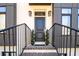 Exterior shot of a modern townhome's front door and entry with brick steps at 1110 Briar Cove Cir, Atlanta, GA 30329