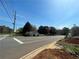 Exterior view showcasing the home's setting near a road and the surrounding trees at 1510 Bells Ferry Rd, Marietta, GA 30066