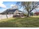 Scenic backyard featuring a wooden patio, mature trees, and a well-maintained lawn at 2019 Wiltshire Pl, Snellville, GA 30078