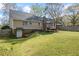 Spacious backyard featuring a large lawn, wooden deck, and mature trees at 2019 Wiltshire Pl, Snellville, GA 30078