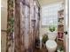 Bathroom with decorative wood-themed shower curtain, white toilet, and convenient shelving at 2019 Wiltshire Pl, Snellville, GA 30078