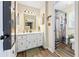 Bathroom featuring wood floors, a modern vanity and a shower and tub combo at 2019 Wiltshire Pl, Snellville, GA 30078