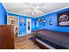 Blue bedroom featuring a ceiling fan, hard wood floors and a brown wood dresser at 2019 Wiltshire Pl, Snellville, GA 30078