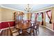 Dining room featuring a large table, decorative hutch, and natural light from the bay windows at 2019 Wiltshire Pl, Snellville, GA 30078
