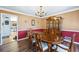 Traditional dining room with a polished table, hutch, and views into another dining space at 2019 Wiltshire Pl, Snellville, GA 30078