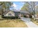 Charming home featuring a stone facade and a long driveway nestled amongst mature trees at 2019 Wiltshire Pl, Snellville, GA 30078