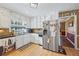 Bright kitchen boasting white cabinetry, stainless steel appliances, and wood-look flooring at 2019 Wiltshire Pl, Snellville, GA 30078