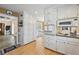 Spacious kitchen featuring white cabinets, built-in oven, and seamless access to dining area at 2019 Wiltshire Pl, Snellville, GA 30078