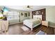 Stylish main bedroom with modern decor, wood accent wall and lots of natural light at 2019 Wiltshire Pl, Snellville, GA 30078