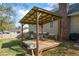 Charming outdoor space featuring a pergola with hanging lights and a comfortable seating area at 2019 Wiltshire Pl, Snellville, GA 30078