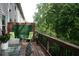 Back deck with an outdoor table, chairs, privacy fence, and view of mature landscaping at 2022 Raven Way, Atlanta, GA 30341
