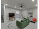 Finished basement area with a green sofa, exercise bike, television, and neutral carpet at 2022 Raven Way, Atlanta, GA 30341