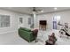 Finished basement includes a green sofa, television, work out equipment, and door to unfinished area at 2022 Raven Way, Atlanta, GA 30341