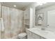 Bathroom with white cabinets, a shower with a patterned curtain, and a decorative mirror at 2022 Raven Way, Atlanta, GA 30341