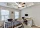Bright bedroom with a tray ceiling, two windows, and a dedicated desk area at 2022 Raven Way, Atlanta, GA 30341