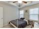 Cozy bedroom with a tray ceiling, ceiling fan, and bright natural light at 2022 Raven Way, Atlanta, GA 30341