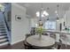 Open dining area featuring hardwood floors, modern lighting and a view of the kitchen at 2022 Raven Way, Atlanta, GA 30341