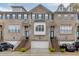 Brick townhomes featuring attached garages and professional landscaping at 2022 Raven Way, Atlanta, GA 30341