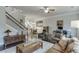 Open-concept living room with hardwood floors, stairway access, and dining area at 2022 Raven Way, Atlanta, GA 30341