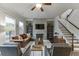 Inviting living room featuring a stone fireplace, hardwood floors, and abundant natural light at 2022 Raven Way, Atlanta, GA 30341