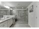 Bright main bathroom with granite countertops, double sinks, large mirrors, and a spacious glass-enclosed shower at 2022 Raven Way, Atlanta, GA 30341