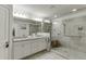 A spacious main bathroom boasts double vanities, a glass shower, and elegant fixtures at 2022 Raven Way, Atlanta, GA 30341
