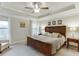 Main bedroom featuring a tray ceiling, ceiling fan, and patterned wallpaper at 2022 Raven Way, Atlanta, GA 30341