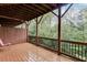 Covered back patio featuring a wooden deck floor, wood railing, and scenic wooded views at 2022 Raven Way, Atlanta, GA 30341