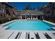 Community pool with clear blue water, surrounded by lounge chairs and umbrellas at 2022 Raven Way, Atlanta, GA 30341