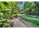 Lush backyard garden oasis with winding paths and shaded seating offering a peaceful retreat at 2440 Peachtree Nw Rd # 22, Atlanta, GA 30305