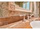 Marble countertop and mirror with decorative frame in this luxurious bathroom at 2440 Peachtree Nw Rd # 22, Atlanta, GA 30305
