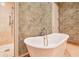 Close-up of soaking tub adjacent to glass enclosed shower with neutral color scheme at 2440 Peachtree Nw Rd # 22, Atlanta, GA 30305