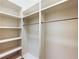 Custom walk-in closet with built-in shelving and chrome hanging rods at 2440 Peachtree Nw Rd # 22, Atlanta, GA 30305