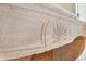 Close-up of a stone fireplace with a unique carved design at 2440 Peachtree Nw Rd # 22, Atlanta, GA 30305
