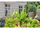Landscaped front yard with planter filled with pink vincas, greenery, and wrought iron seating at 2440 Peachtree Nw Rd # 22, Atlanta, GA 30305
