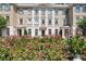 Beautiful three-story building with a brick facade and meticulously landscaped front yard with colorful roses at 2440 Peachtree Nw Rd # 22, Atlanta, GA 30305