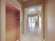 Spacious hallway features an elevator, travertine floors, and views into the living areas at 2440 Peachtree Nw Rd # 22, Atlanta, GA 30305