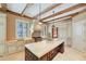 Spacious kitchen features a large island, granite counters, and exposed wooden beams overhead at 2440 Peachtree Nw Rd # 22, Atlanta, GA 30305
