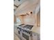 Gourmet kitchen features a professional-grade Wolf range and custom stone vent hood at 2440 Peachtree Nw Rd # 22, Atlanta, GA 30305