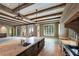 Expansive living room boasts exposed beams, travertine floors, and access to a balcony at 2440 Peachtree Nw Rd # 22, Atlanta, GA 30305