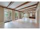 Expansive living area with travertine floors and multiple French doors at 2440 Peachtree Nw Rd # 22, Atlanta, GA 30305