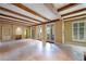 Spacious living room with exposed wood beams and travertine floors at 2440 Peachtree Nw Rd # 22, Atlanta, GA 30305