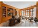 Office with wood paneling, travertine floors, and built-in bookshelves with desk at 2440 Peachtree Nw Rd # 22, Atlanta, GA 30305