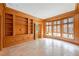 Office with wood paneling, travertine floors, and built-in bookshelves at 2440 Peachtree Nw Rd # 22, Atlanta, GA 30305